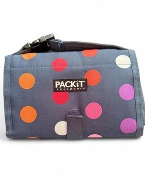 PACKIT Freezable lunch bag with multicolored polka dots on navy blue background.